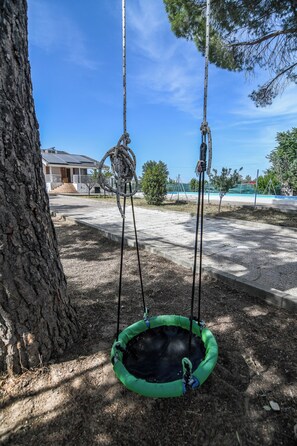 A tree with a swing hanging from its branches. - Casa Dolly - Elegant Villa directly on the Tajo (VIILLAMANRIQUE DE TAJO)