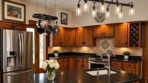A modern kitchen with stainless steel appliances, wooden cabinets, a granite countertop, and a hanging light fixture.