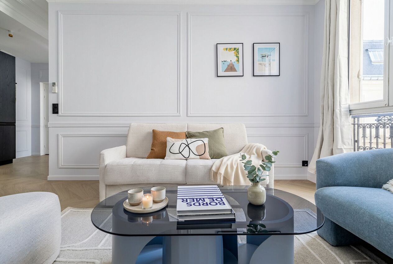 Ein modernes Wohnzimmer mit einer Couch, einem Couchtisch und einem Bücherregal.