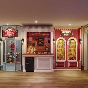 A themed room with a Donald Duck and Mickey Toy sign, a bar area, and a toy display. - 7BR house at Windsor Cay Resort (Clermont)