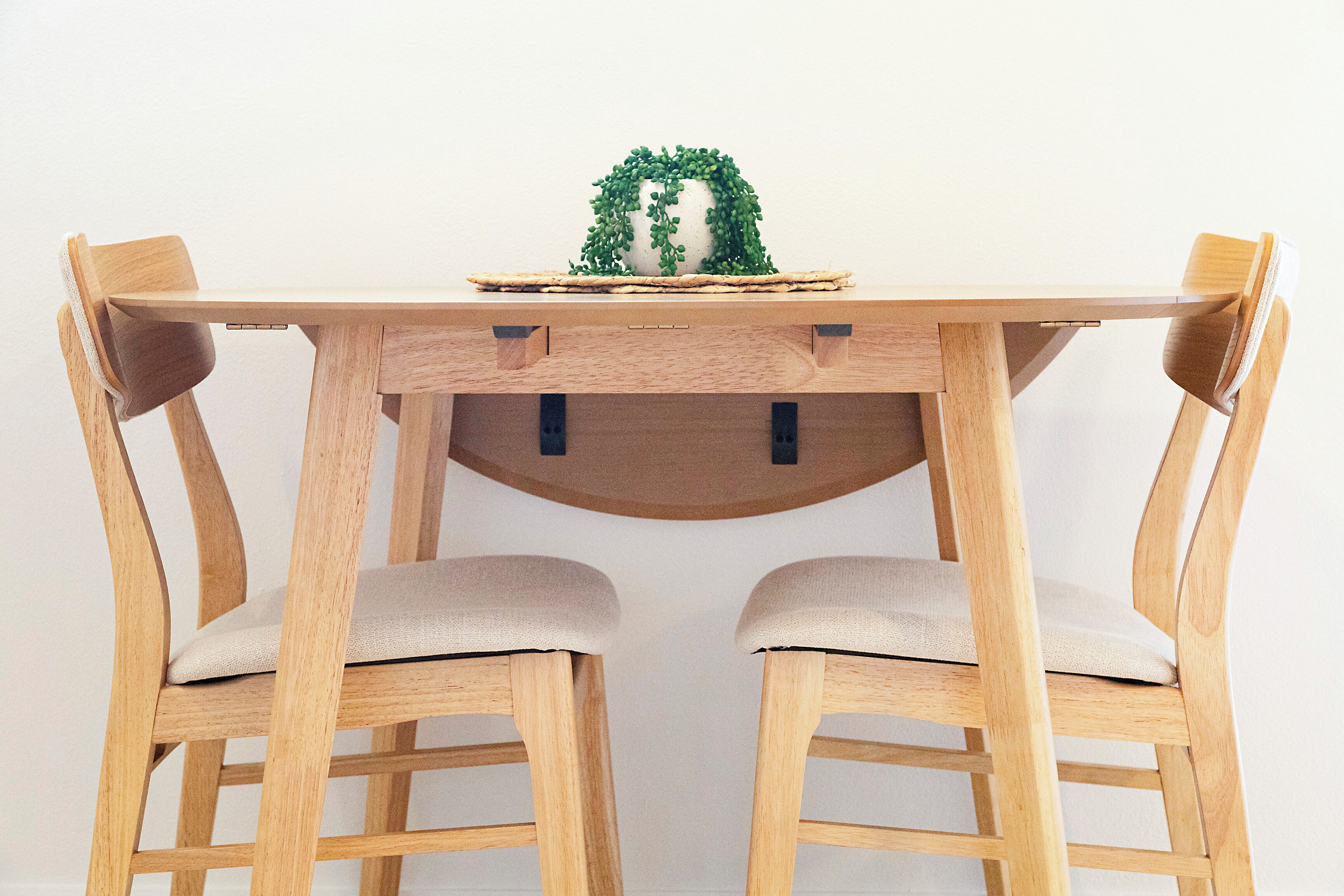 A wooden dining table with two chairs.