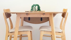 A wooden dining table with two chairs.