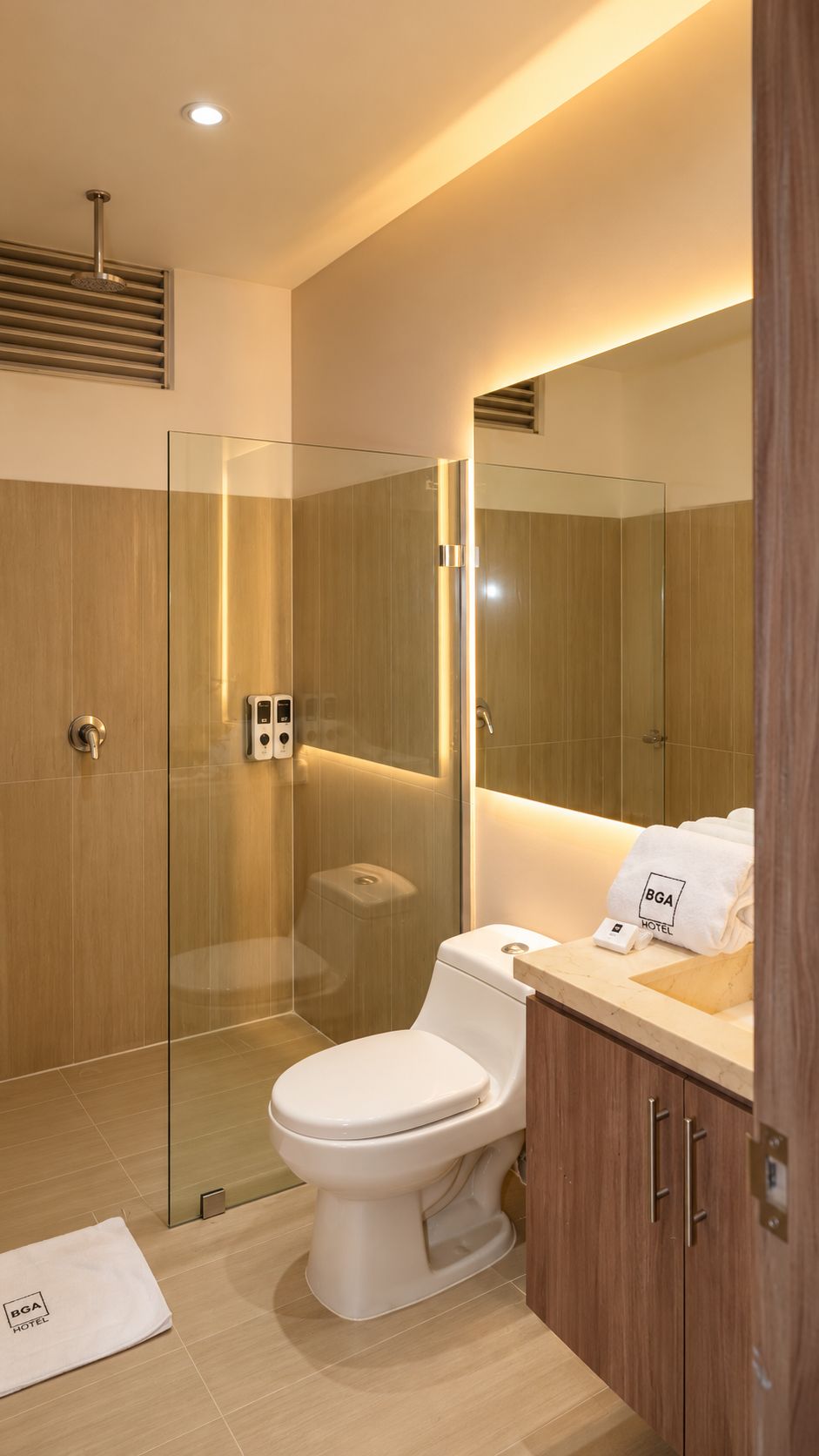 A modern bathroom with a glass-enclosed shower, a toilet, and a vanity with a mirror.