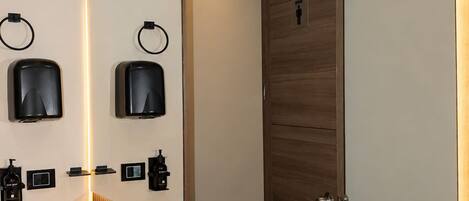 A modern bathroom with a large mirror, two sinks, and a wooden panel design.