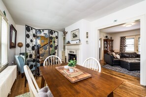 Un comedor con una mesa de madera, sillas y un centro decorativo.