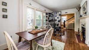 A dining area with a wooden table, chairs, and a decorative plant centerpiece. - On Johnson Pond _ Near Downtown and SU (Salisbury)