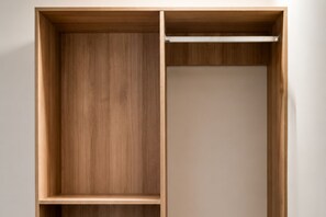 A wooden wardrobe with a hanging rod and a shelf. - 1BR with Bay Views, Pool & 24h Gym in Downtown Miami G1918 (Miami Beach)