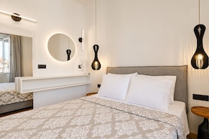 A hotel room with a bed, a bedside table, a mirror, and a hanging light fixture. - Casa Dei Padri #2 - Historic Center (Corfu)