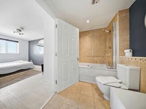 A modern bathroom with a bathtub, toilet, and shower. - 63 Vista Heights (Solihull)