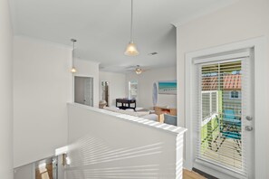 A modern interior with a staircase, a ceiling fan, and a view of the outside through a window with blinds. - Sleeps 10 l 3 Min to Beach l Pool l Game Room l Wireless Internet l Pompano Joes (Miramar Beach)