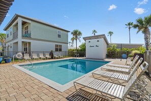 A swimming pool with lounge chairs and a sign reading 'Leisure Bay.' - Sleeps 10 l 3 Min to Beach l Pool l Game Room l Wireless Internet l Pompano Joes (Miramar Beach)