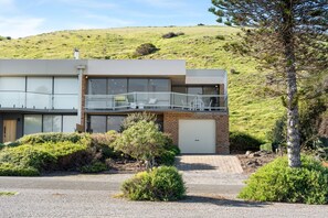 A modern two-story building with a balcony, a garage, and a driveway. - Carrickalinga House A Symphony of Sea and Serenity (Carrickalinga)