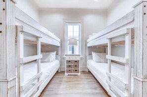 A room with bunk beds, a window, and a lamp. - Beach Vista Two Beach House (Orange Beach)