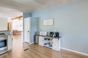 A compact kitchen with a microwave, coffee maker, and a small trash bin. - Spacious Waterfront Home on Smith Mountain Lake (Moneta)