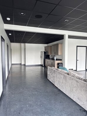 A modern kitchen with dark flooring, a sofa, and a door. - Superb 6-bedroom house on Lake of Egypt. The view is beautiful.  (Goreville)