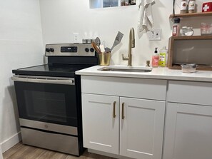 A kitchen with a stove, oven, sink, and cabinets. - Cozy West Elm Stay Near Expo & Mountain Fun (Sandy)