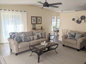 A living room with two sofas, a coffee table, and a ceiling fan. - 
This beautiful stick-built home has just been remodeled. In Spanish Springs (Lady Lake)