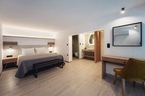 A modern bedroom with a bed, bedside tables, a desk, and a chair. - Chalkidiki Peaceful Retreat With Private Parking (Sithonia)