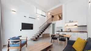 A modern living space with a staircase, a dining area, and a kitchen. - Chalkidiki Peaceful Retreat With Private Parking (Sithonia)