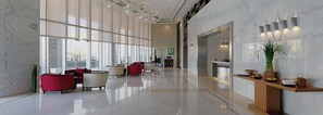A spacious lobby with a modern design, featuring a reception desk, seating area with red and white chairs, and large windows allowing natural light. - Iconic Waterside Studio  Near Dubai Mall (Dubai)