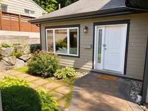 A residential property with a well-maintained garden, a front door, and a mailbox.