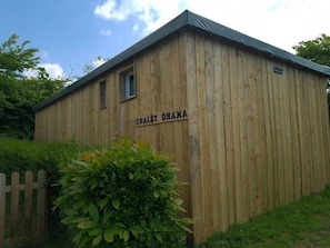 A wooden building with the sign 'CHALET OHANA' on its side.