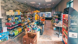 A grocery store interior with shelves stocked with beverages, snacks, and a refrigerated section. - Cozy Kaatsheuvel Chalet (Kaatsheuvel)
