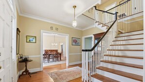 A staircase with white railings and wooden steps leading to a second floor. - Classic 5BR Davidson Retreat Walk Downtown Pet-friendly (Davidson)