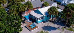 A beachfront property with a large deck, multiple rooms, and a pool area. - Beach Life 2 - Sunshine Lane (Treasure Island)