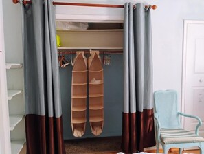 A room with a bed, a chair, a wardrobe, and curtains. - Charming Apartment in a Serene Location  Close to FIT & Everything (Melbourne)