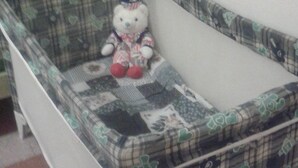 A crib with a Hello Kitty design, positioned against a wall in a room with a tiled floor. - At Anita's, a bright apartment with easy access to the historic center. (Roma)