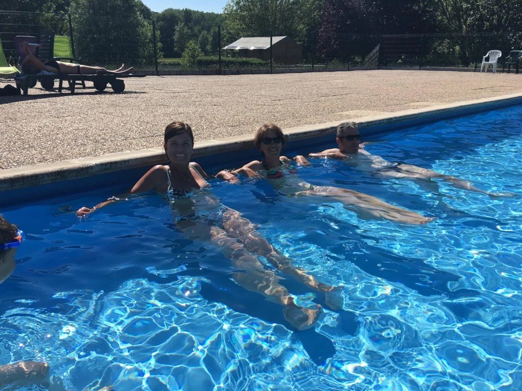 A swimming pool with clear water and a tiled edge.