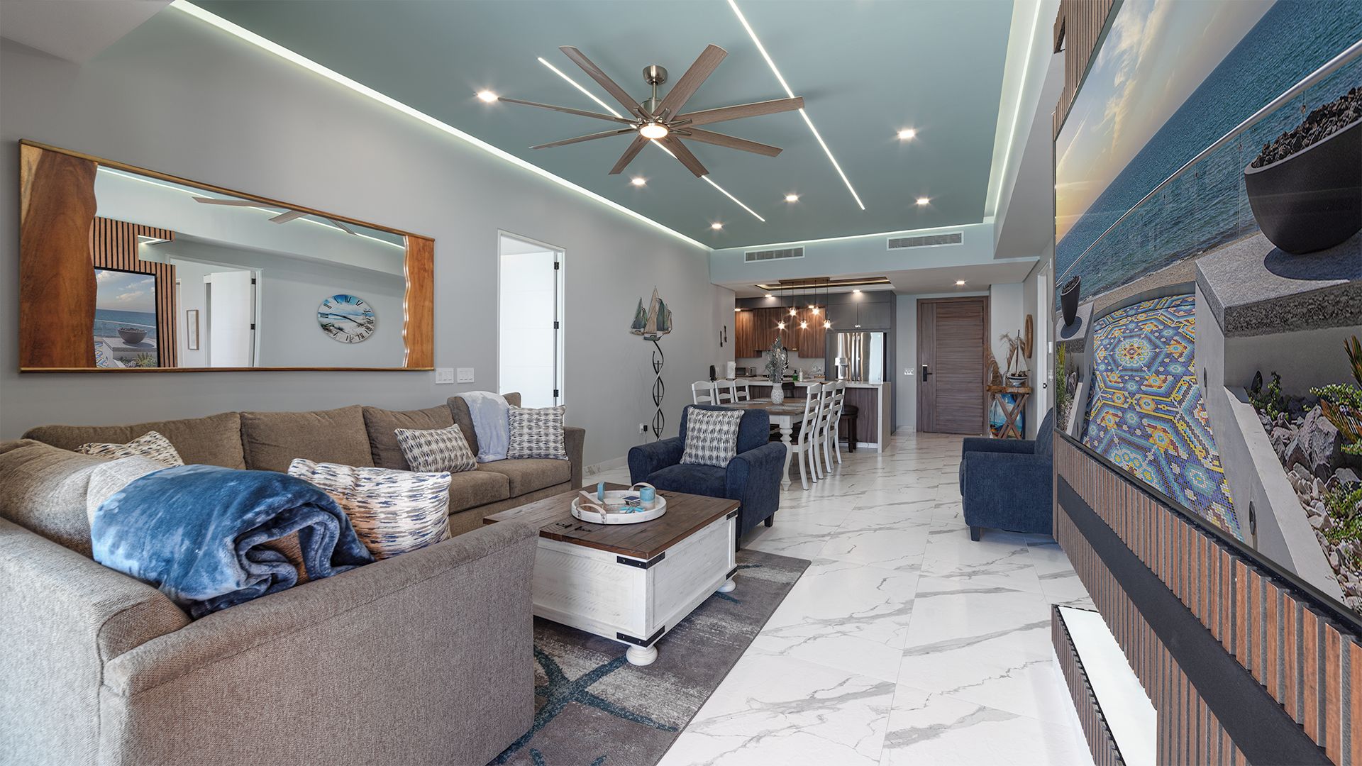 A modern living room with a sofa, coffee table, and a dining area with chairs.