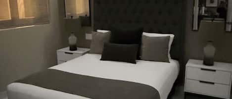 A modern bedroom with a large bed, bedside tables, and a nightstand.