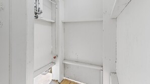 A room with white walls, a wooden floor, and visible plumbing fixtures. - Beach Please, Ocean Front Retreat (Ocean Isle Beach)