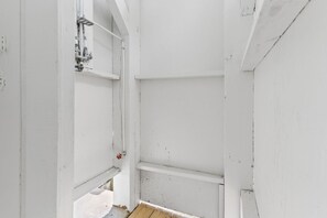 A room with white walls, a wooden floor, and visible plumbing fixtures. - Beach Please, Ocean Front Retreat (Ocean Isle Beach)
