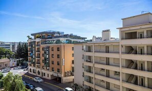 A multi-story residential building with balconies, a parking area, and a clear sky. - TASTEFULLY DECORATED WITH MODERN ELEGANCE, STEPS FROM LA CROISETTE & BEACHES. (Cannes)