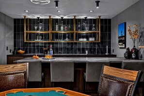 A bar area with a high ceiling, recessed lighting, and a modern design. - Brand-New Luxury Lodge | 17 Private Acres | 30 Minutes to Yellowstone (Livingston)