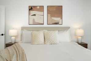 A neatly made bed with two pillows, two bedside tables with lamps, and two abstract paintings on the wall. - 2BR Scottsdale Ranch Retreat w/ Patio & BBQ (Scottsdale)