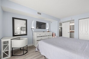 A bedroom with a bed, a desk, a dresser, and a mirror. - Spacious 3-bedroom 3-bathroom beachfront condo in North Myrtle Beach (North Myrtle Beach)