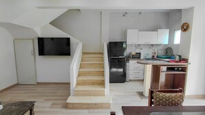 A modern kitchen with a built-in oven, microwave, and refrigerator.