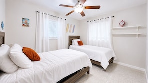 A bedroom with two beds, white bedding, a ceiling fan, and a clock on the wall. - Tropical Pool Oasis, Pet Friendly & Near Beaches! (Seminole)