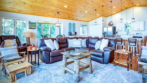 A spacious living area with a large sectional sofa, a coffee table, and a ceiling fan. - Blue Mountain Breeze with multi-mountain range vie (Blowing Rock)