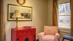 A room with a red cabinet, a framed picture, a striped chair, and a window with curtains. - The Hill is the best in country living, minutes fr (Blowing Rock)
