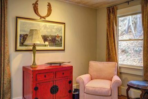 A room with a red cabinet, a framed picture, a striped chair, and a window with curtains. - The Hill is the best in country living, minutes fr (Blowing Rock)