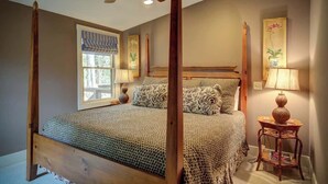 A four-poster bed with a canopy, a ceiling fan, a window with blinds, and two wall-mounted lamps. - The Hill is the best in country living, minutes fr (Blowing Rock)