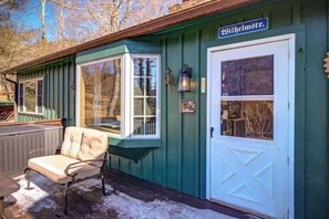 A green building with a white door and windows, a bench outside, and a sign that reads 'Wilhelmstr.' - Uli's Place - Charming spot near the Parkway! (Blowing Rock)