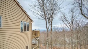 A two-story wooden house with a balcony overlooking a wooded area. - Fair Haven - Great App Ski Mtn Location! (Blowing Rock)