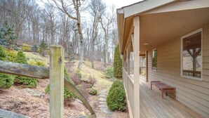 A wooden deck with a bench, a stone pathway, and a view of a forested area. - Fair Haven - Great App Ski Mtn Location! (Blowing Rock)