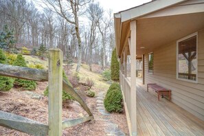 A wooden deck with a bench, a stone pathway, and a view of a forested area. - Fair Haven - Great App Ski Mtn Location! (Blowing Rock)